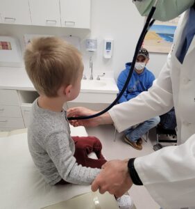 little boy sitting in doctor's office