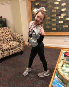 Posing with a peace sign in the front lobby.