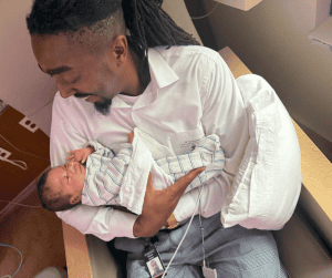 dad with baby in hospital