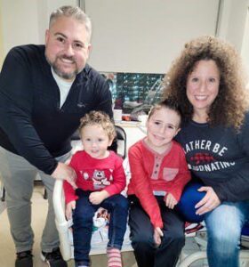 Family seated on hospital bed