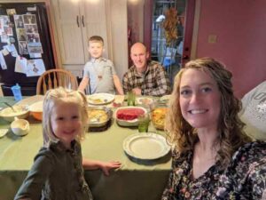 Smiling Family around kitchen table