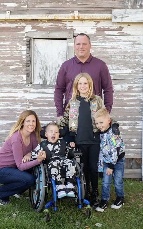 Lindberg family of two adults, a 5-year-old-boy in wheelchair, 10-year-old good girl, father and 5-year-old boy