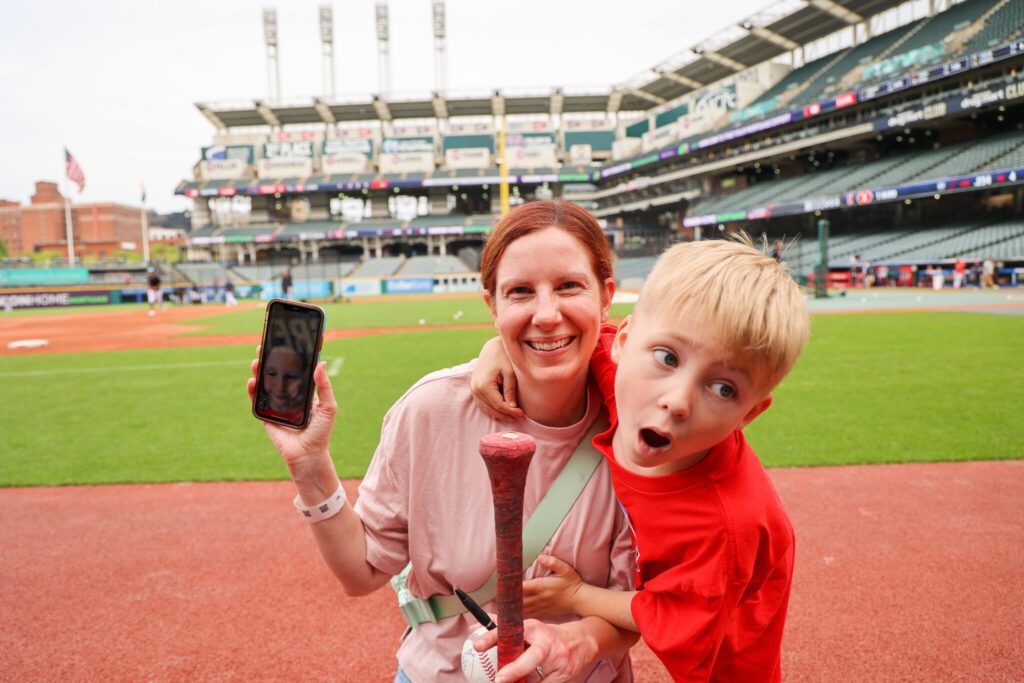 mom shows child she's facetiming with from field along with another child