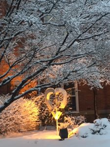 snow on a heart sculpture outside RMH