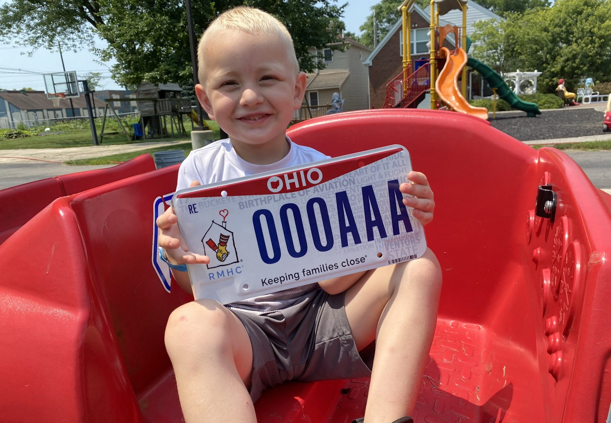 Sam holds the RMHC license plate