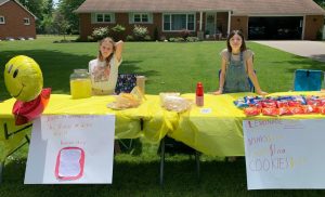 lemonade stand with two girls selling drinks