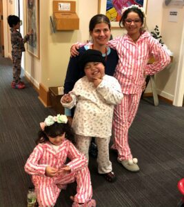 Woman with three children posing in pajamas