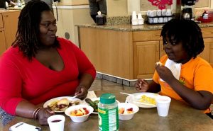 Meal time at the House, Mother and daughter, seated