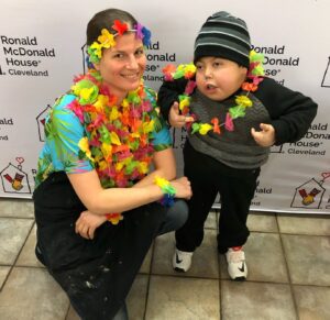 woman and child pose wearing Hawaiian leis on