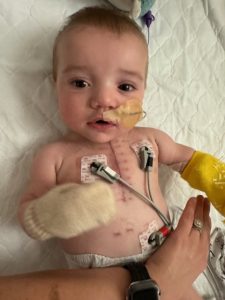 little boy with wires in hospital bed.