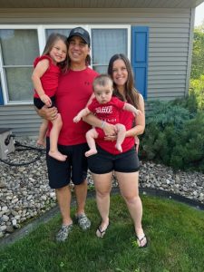 family of four wearing red