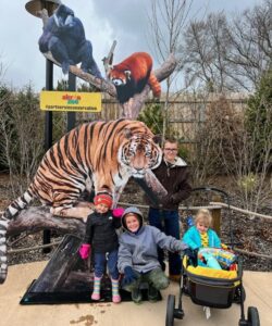 four children with zoo animal sign