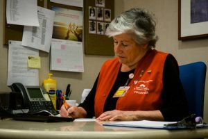 Volunteer Lucy Sims working at a desk