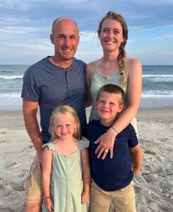 family standing on the beach