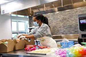 woman making lunches in industrial kitchen