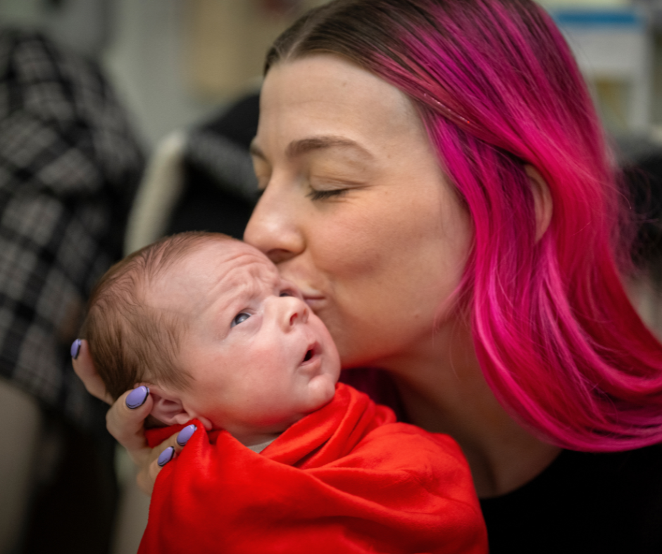 mom kissing baby cheek