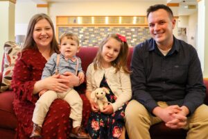 The Vagi Family sitting on a couch together at the Ronald McDonald House