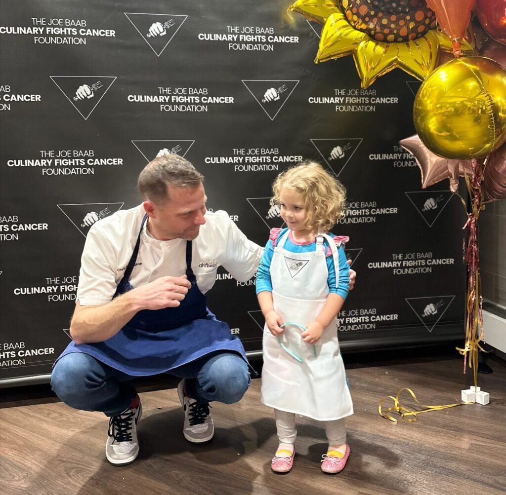 chef and little girl posing for pictures
