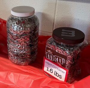 two different size containers full of pull tabs for reference