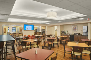 Spacious dining area with tables and a television on one wall.