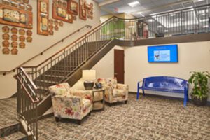 Akron House Entryway with stairs, comfortable seating. 