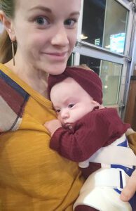 Hilary Heaton holds baby Haddie, who has braces strapped around her legs and back.