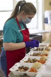 volunteer packaging meals