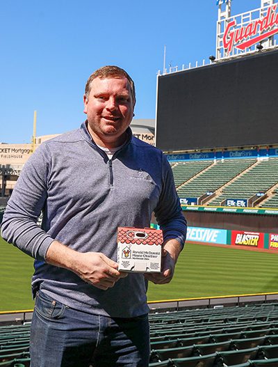 Tyler Mettler holding a pull tab collection House in the ballpark