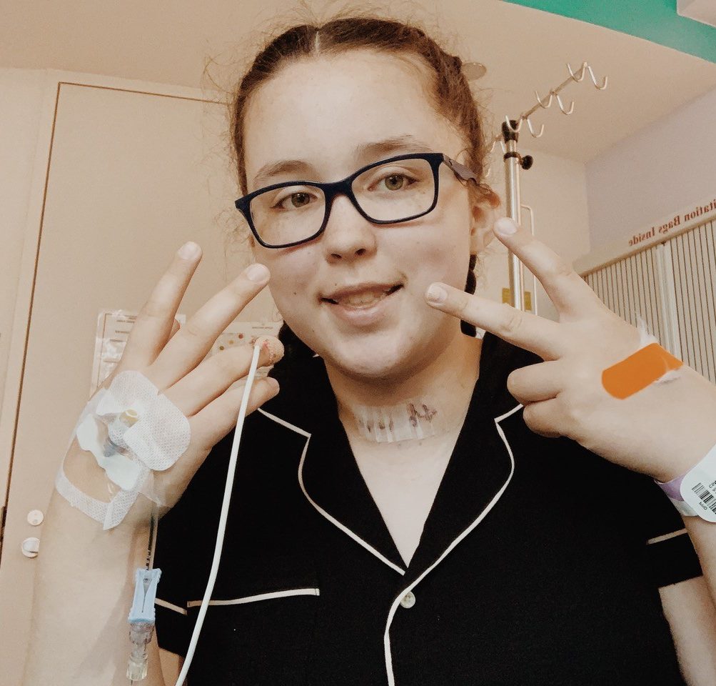 Teenage girl holding up peace signs