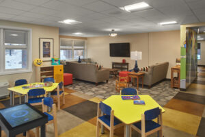 Indoor play area with adjacent seating and television