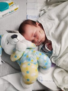 baby sleeping with stuffed dog