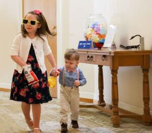 Isla and Finn walking past the wish jar