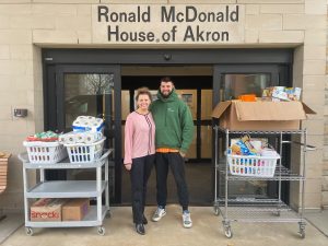 Rebeka Rainsberg and fiancee drop off wish list items in front of RMHA