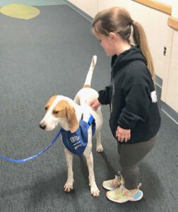 Shae pets a therapy dog at the Ronald McDonald House